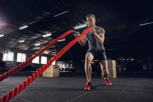 young-healthy-man-athlete-doing-exercise-with-ropes-gym-single-male-model-practicing-hard-training-his-upper-body-concept-healthy-lifestyle-sport-fitness-bodybuilding-wellbeing (1)